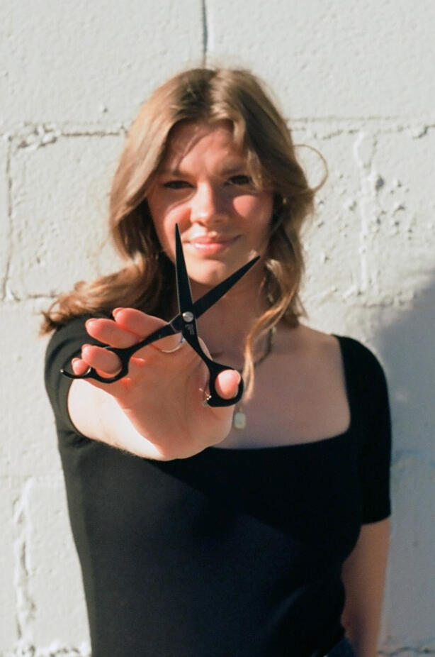 17/10 holding a pair of scissors